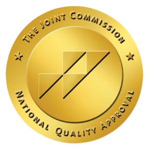 A gold seal that says the joint commission national quality approval.